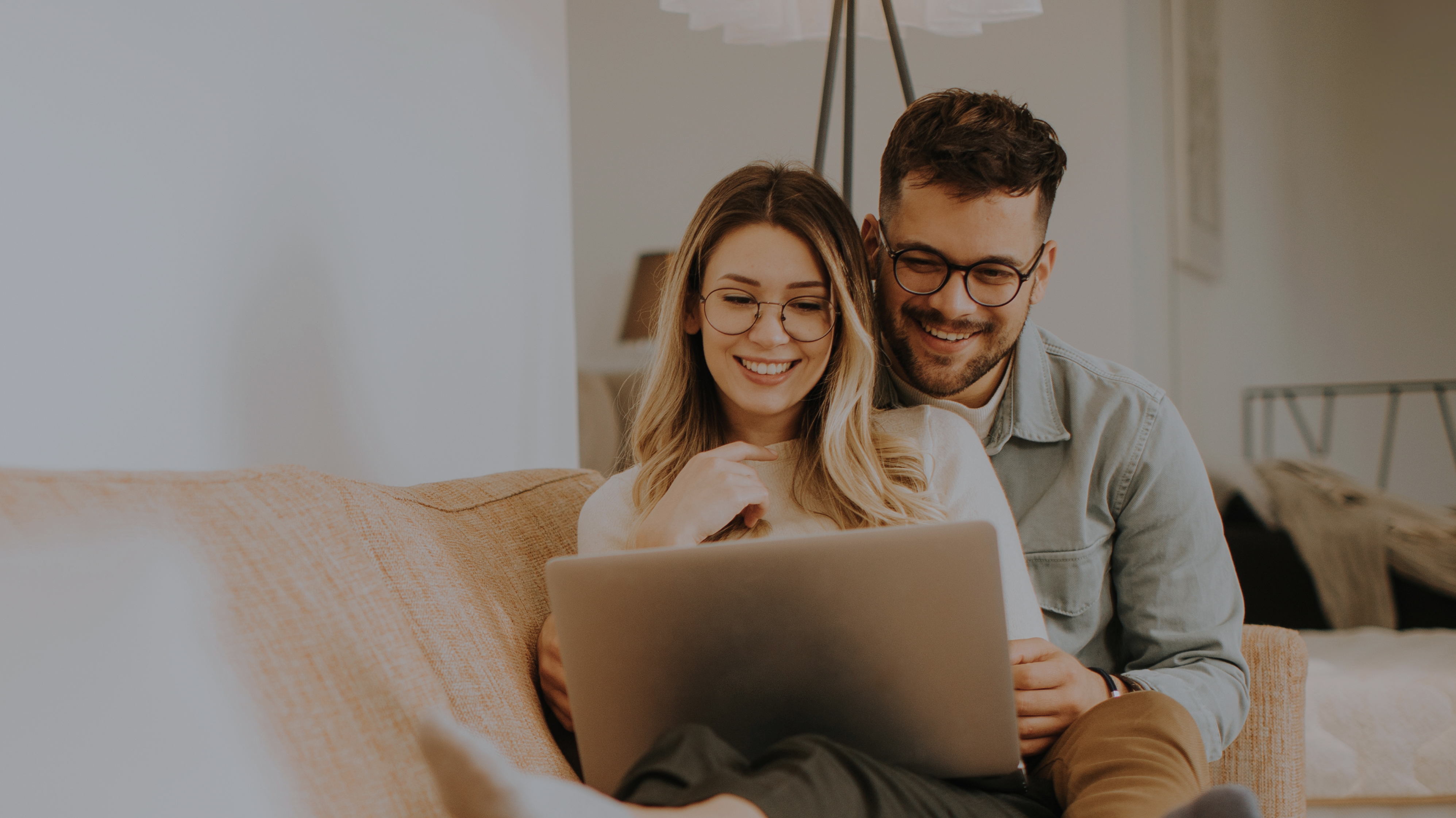a couple on the computer smiling